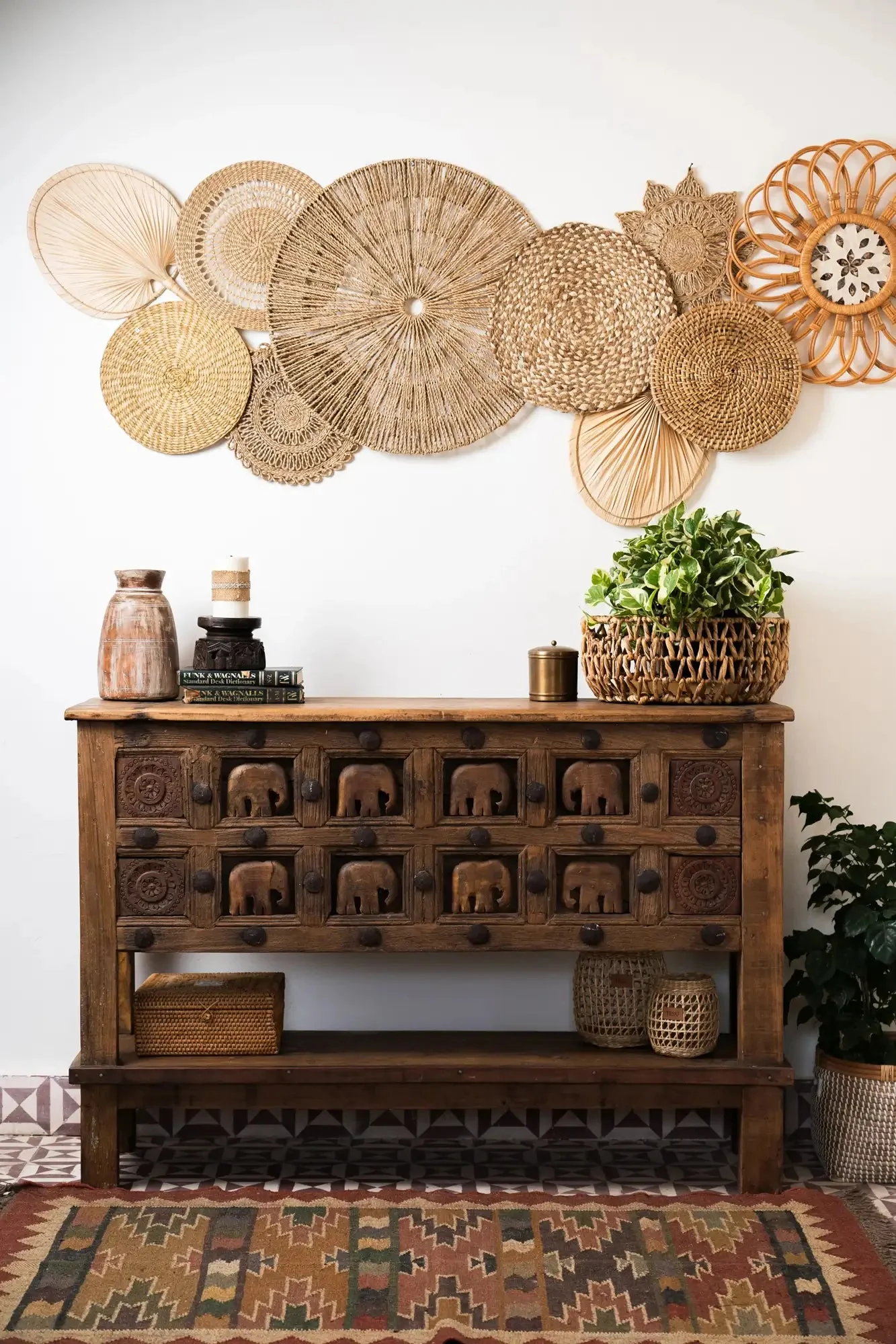 A hand-carved antique wooden cabinet with brass fittings and a warm patina